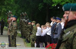 Wojskowa kompania reprezentacyjna oddaje salwę honorową.